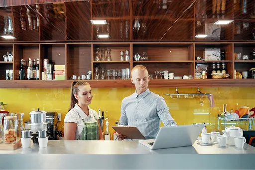 Restaurant counter taking an order and a card payment